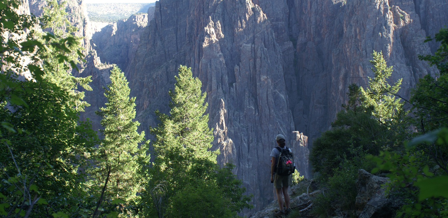 Person by the edge, overlooking a rocky landscape