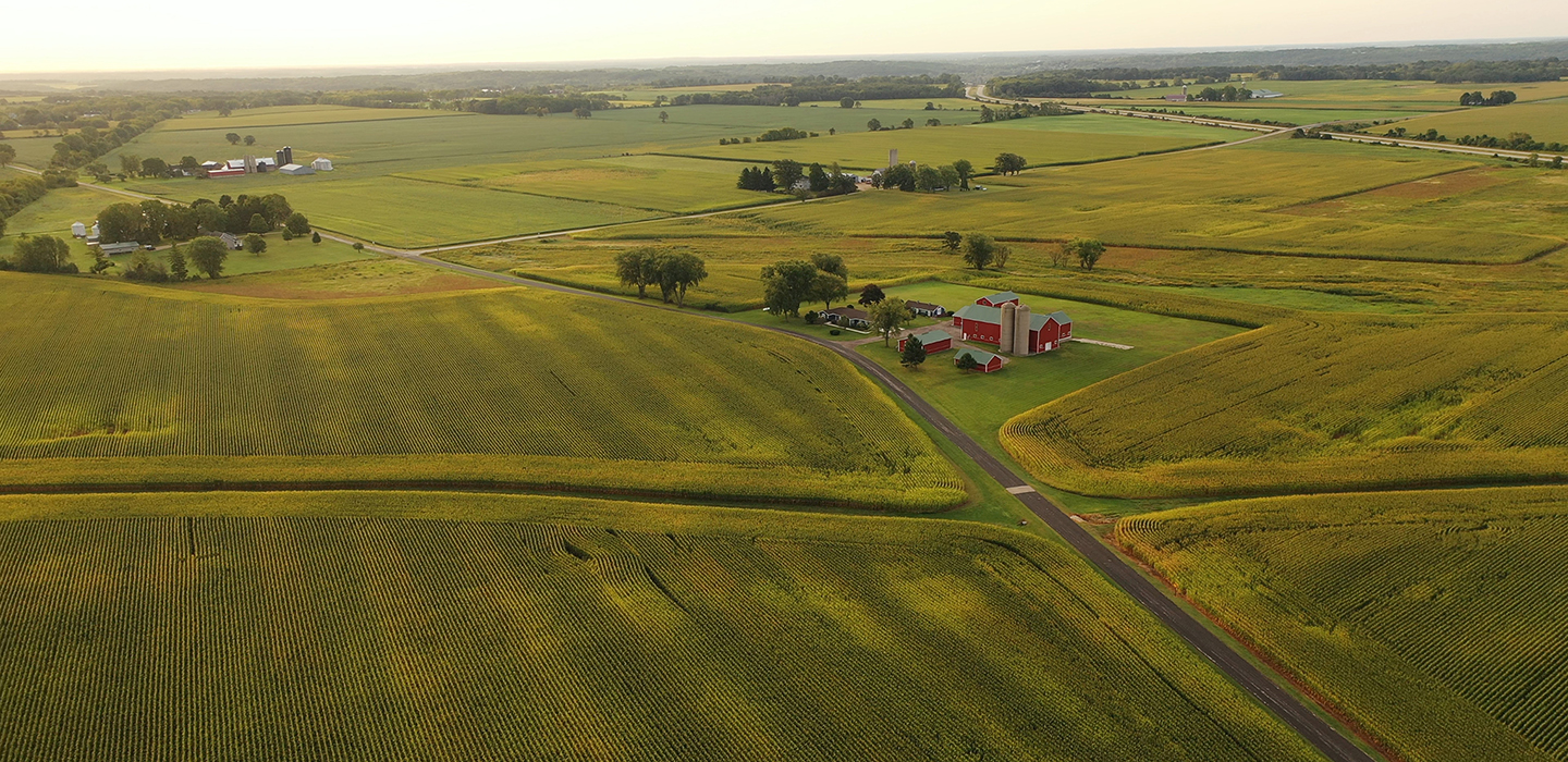 A red barn sticks out against manicured, green farmland in Central Indiana