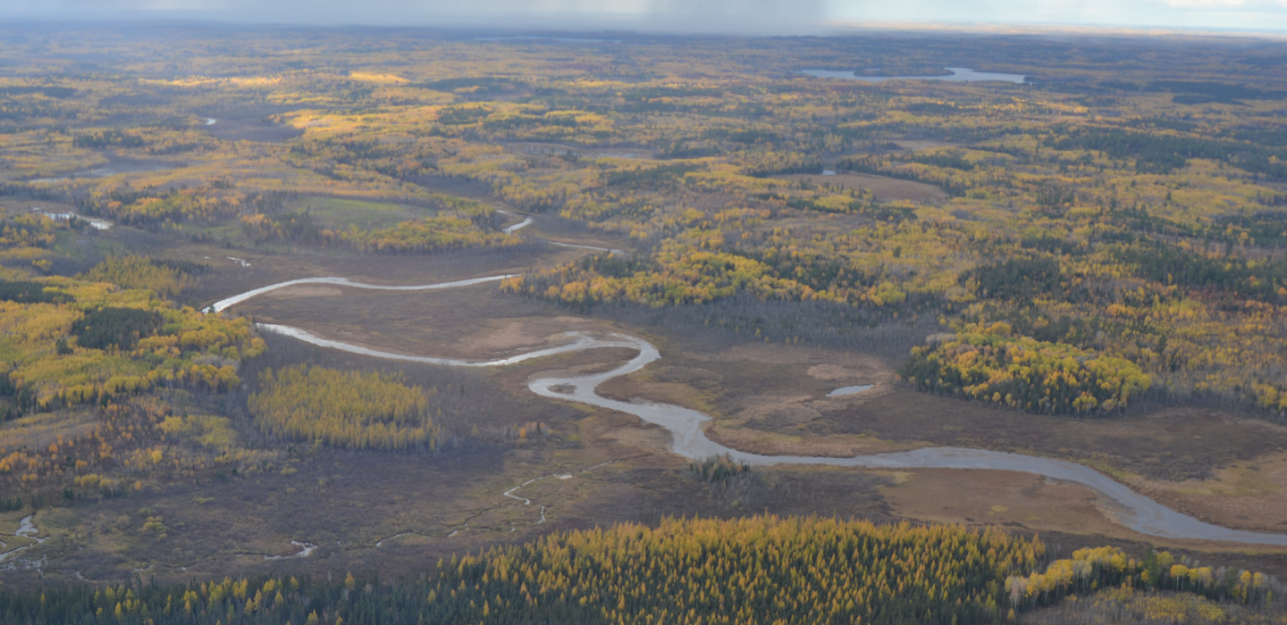Aerial perspective of a river surrounded by trees, situated in the Bois Forte Band of Chippewa reservation area.