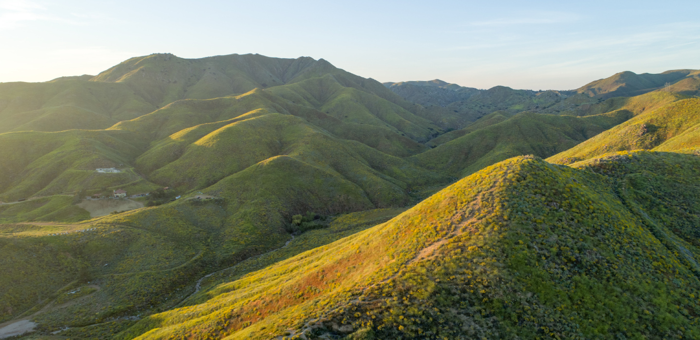 Scenic view of Walker Canyon, California, showcasing a majestic mountain range under a clear blue sky.