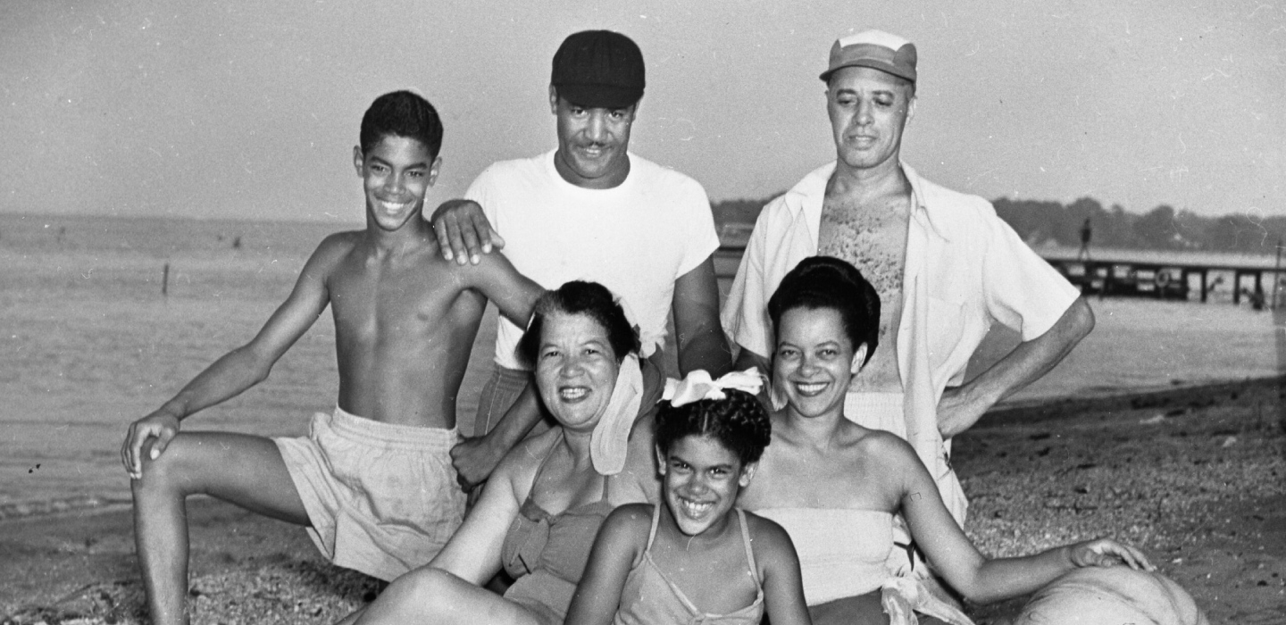 A historic black and white photo depicting Black friends enjoying one of Maryland's Black beaches