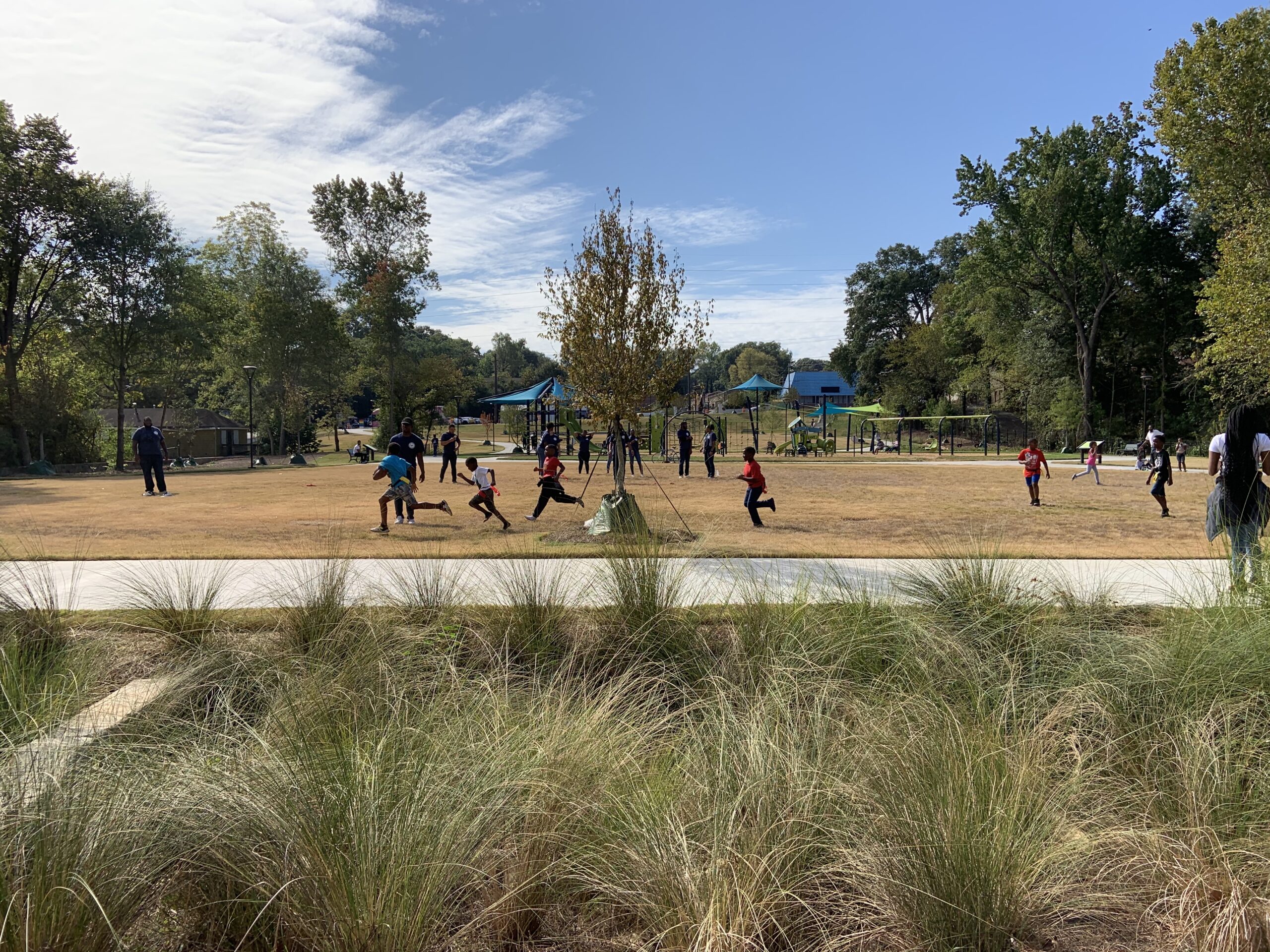 Children playing football during the Kathryn Johnston Memorial Park ribbon cutting