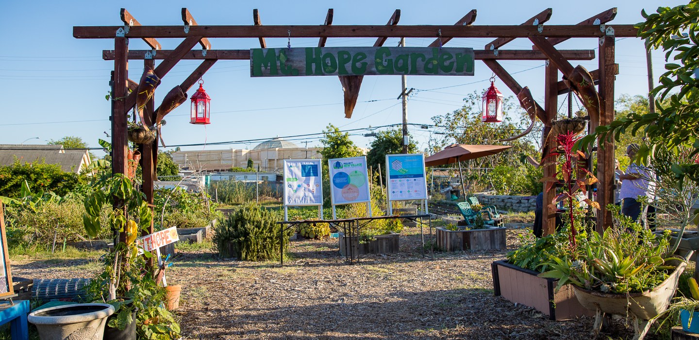 A wooden trellis with a sign that reads 