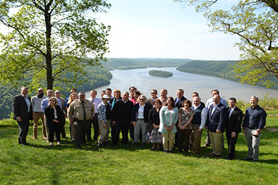 A group of conservations pose in front of the Susquehanna River.