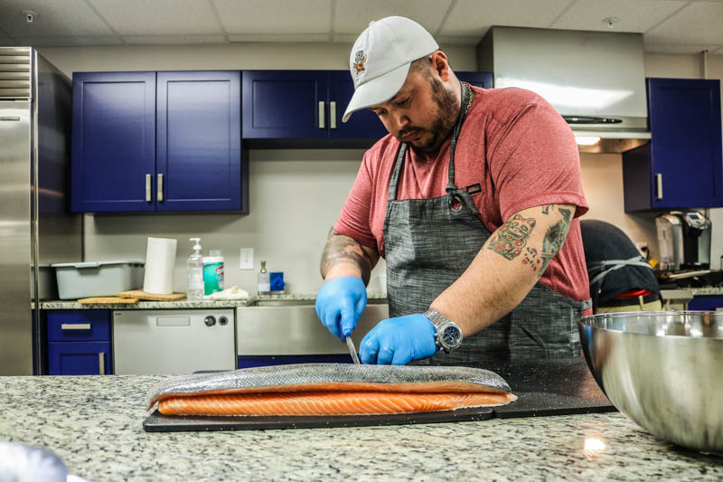 Chef Chad Gauss of The Food Market in Baltimore prepares Freshwater Institute Spring Hill salmon during a tasting at JJ McDonnell in Elkridge, MD.