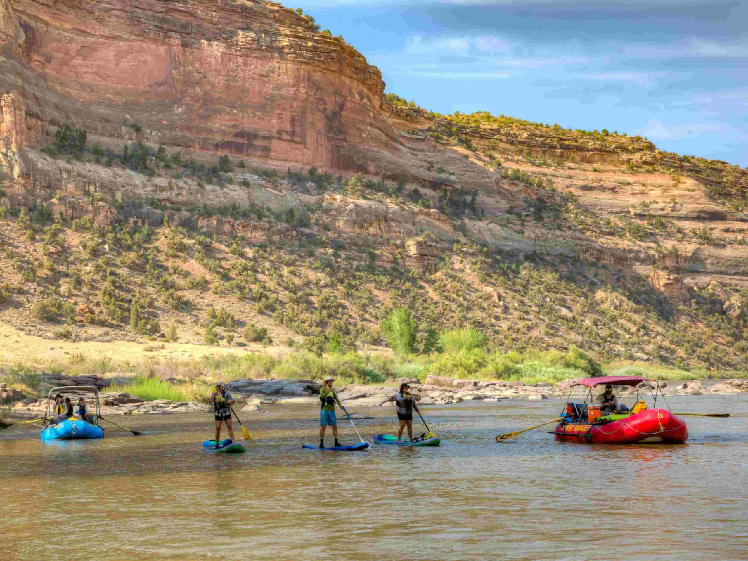 People enjoy recreation such as paddleboarding on the water at McInnis Canyons National Conservation Area