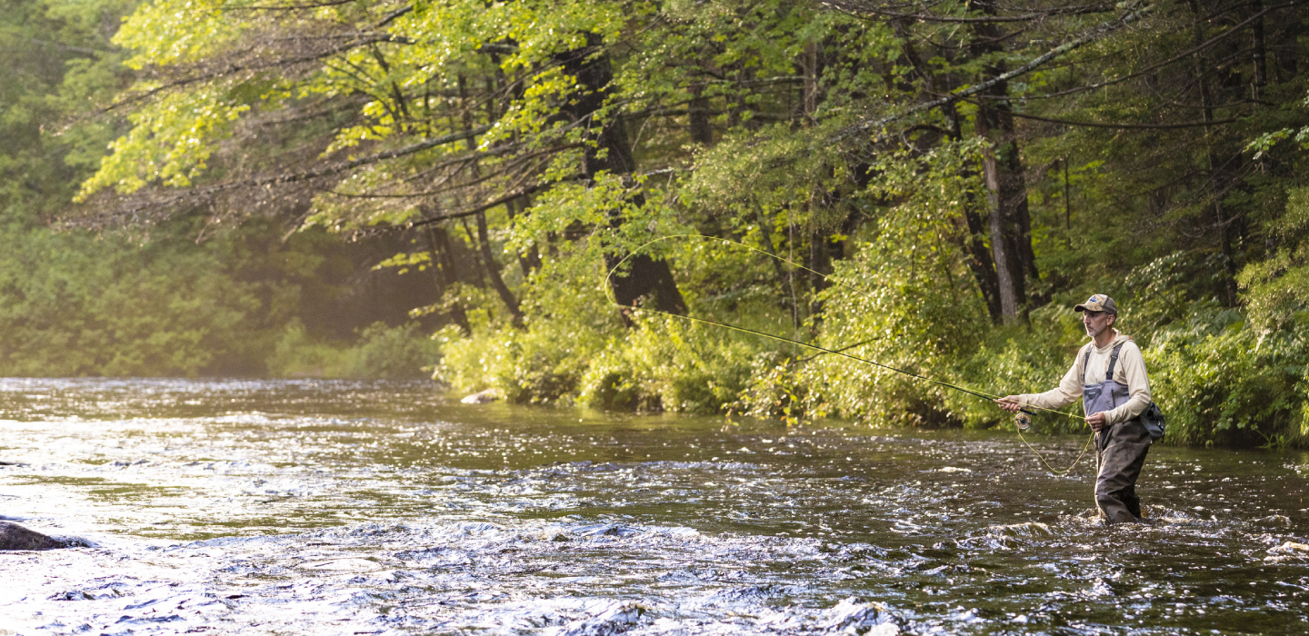 A man fly-fishing on the Crooked River in Norway, Maine