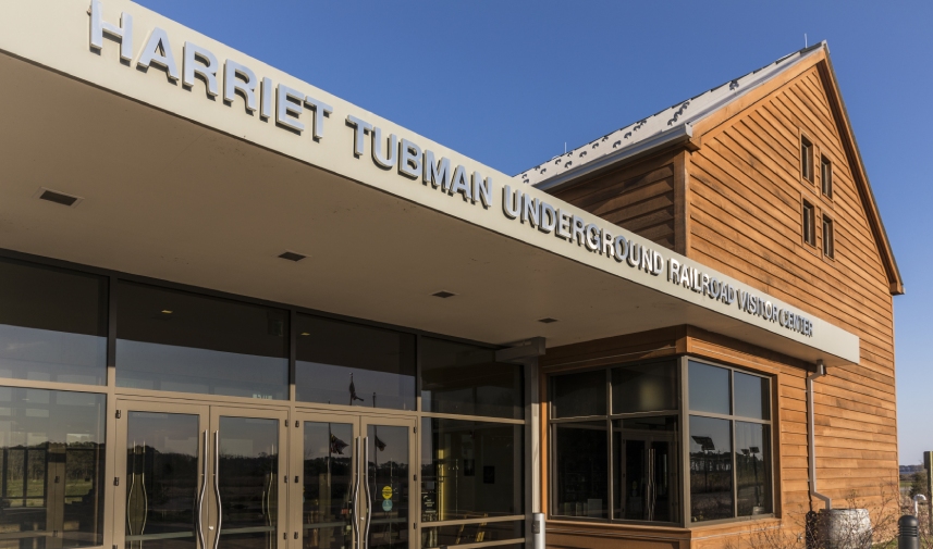 A building with the title, "Harriet Tubman Underground Railroad Visitors Center" against a clear blue sky.