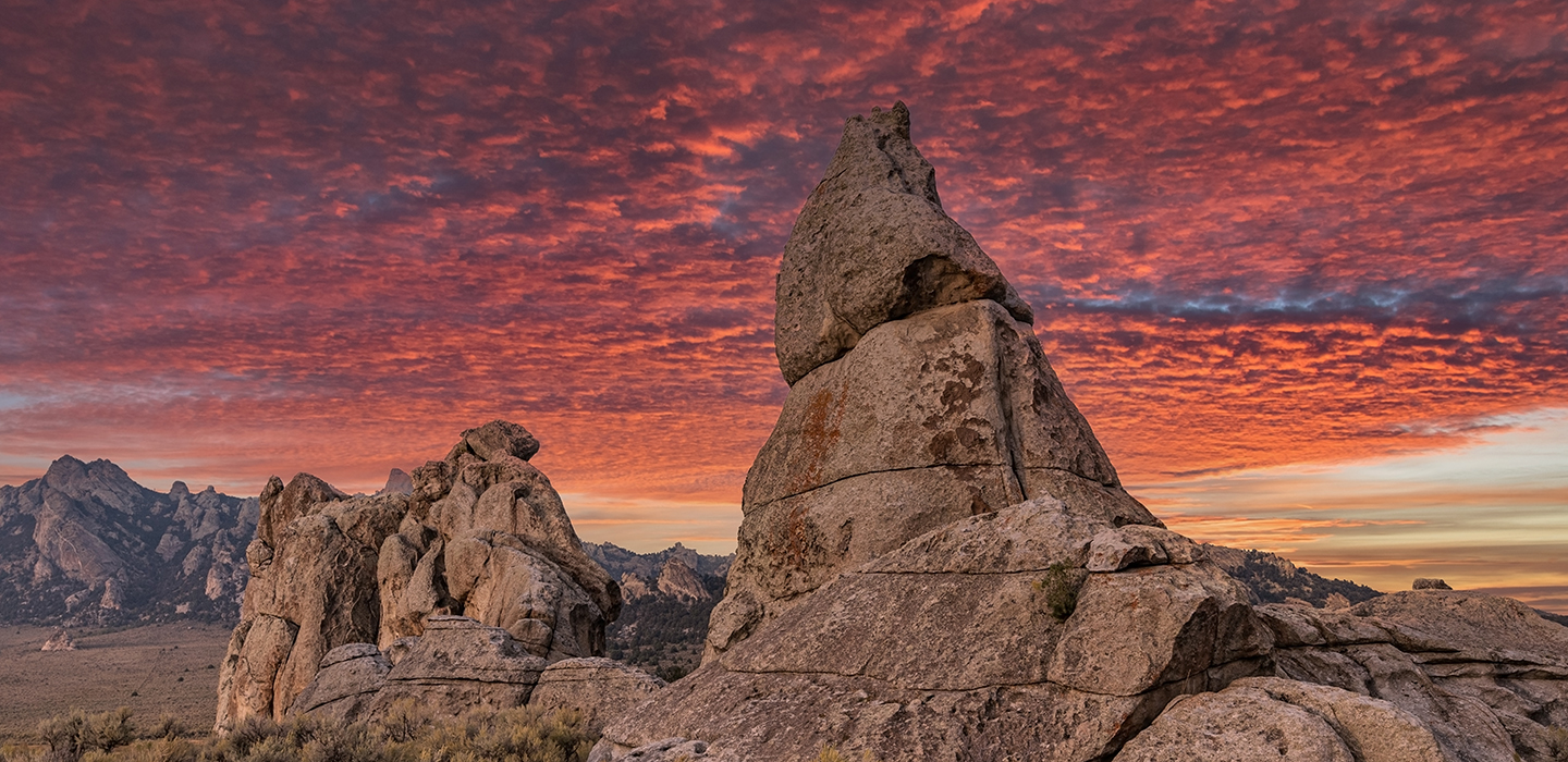 A colorful orange and purple cloudy sunset setting over the natural rock formations of City of Rocks in Idaho