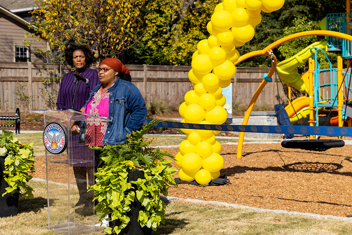 Two women speaking at a podium at Mattie Freeland Park in Atlanta the day it opened to the public