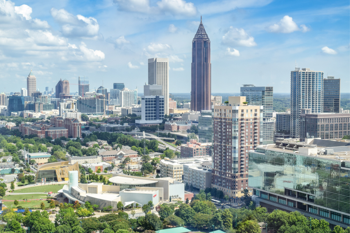 The Atlanta skyline with green trees and grass in the foreground